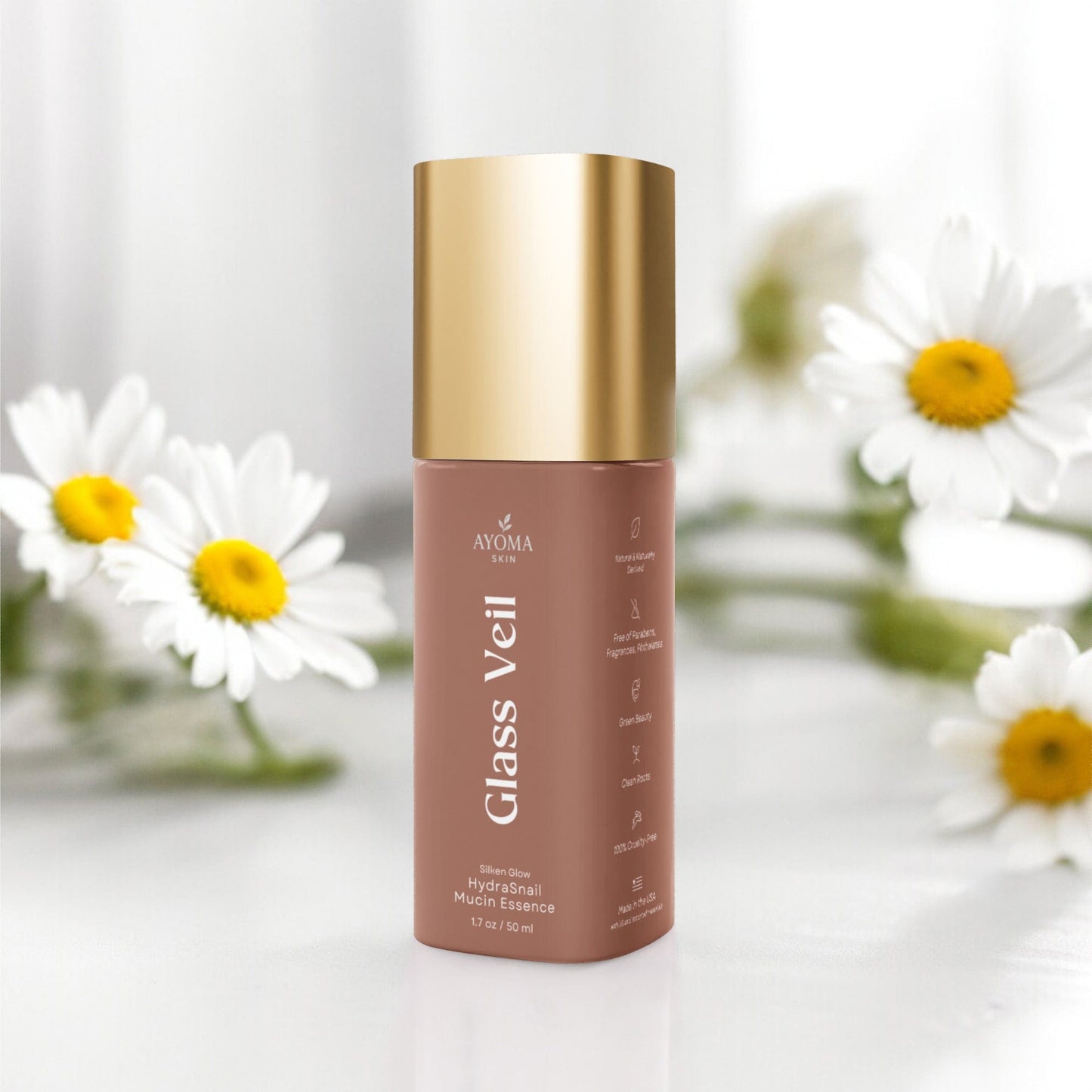 Skincare bottle labeled 'Glass Veil' with a gold cap on a white background with daisies.