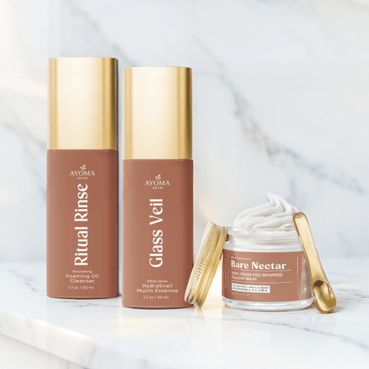 Ayoma Skin Glass Skin Glow Trio—Ritual Rinse, Glass Veil, Bare Nectar on marble, gold accents.